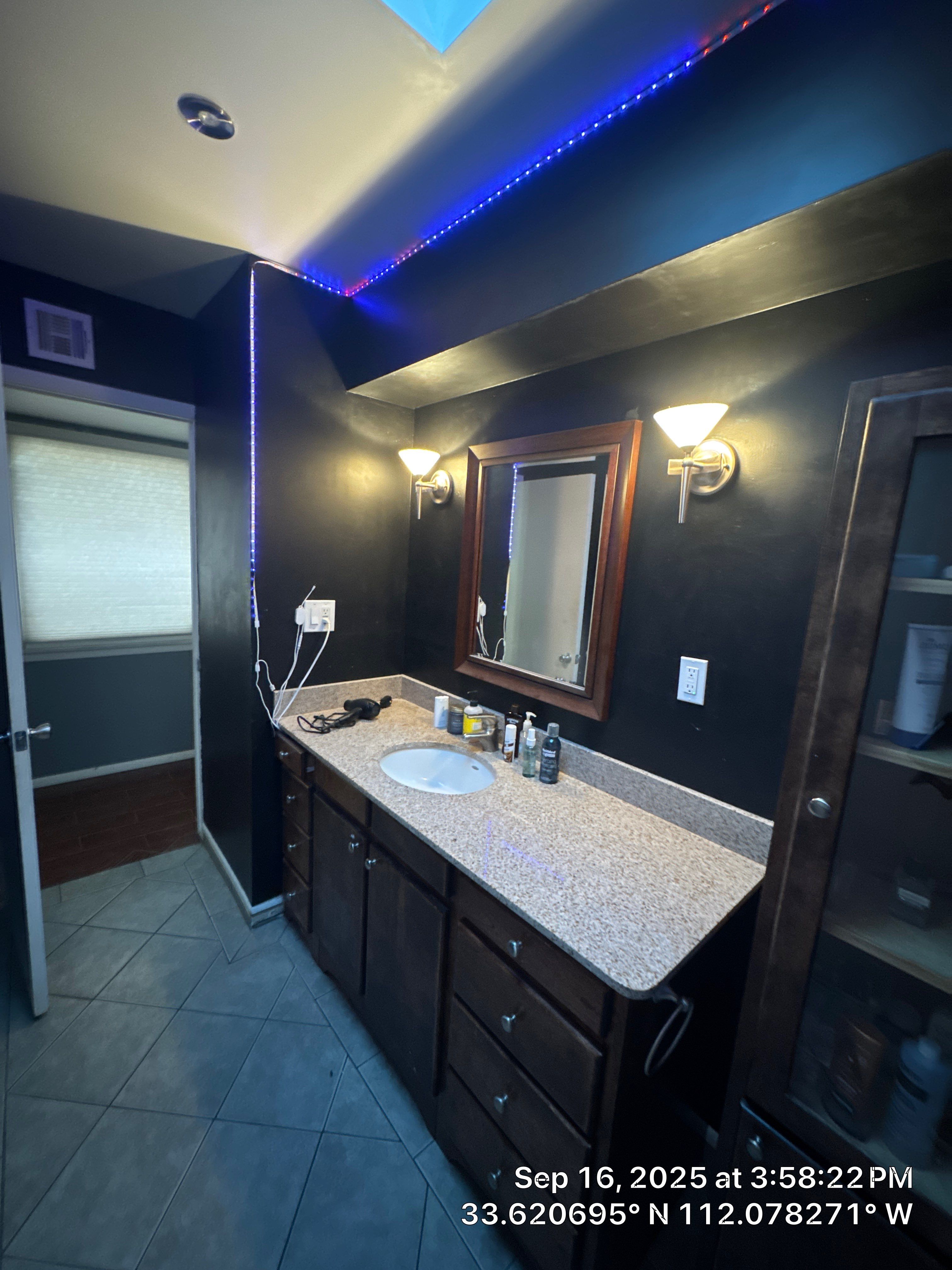 Finished bathroom remodel with dark cabinetry and granite vanity