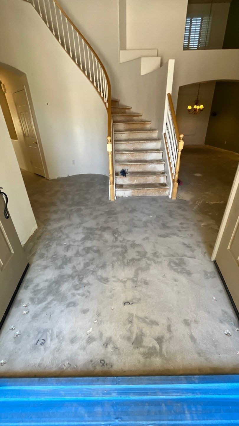 Cleaned concrete slab in a home entryway after tile removal